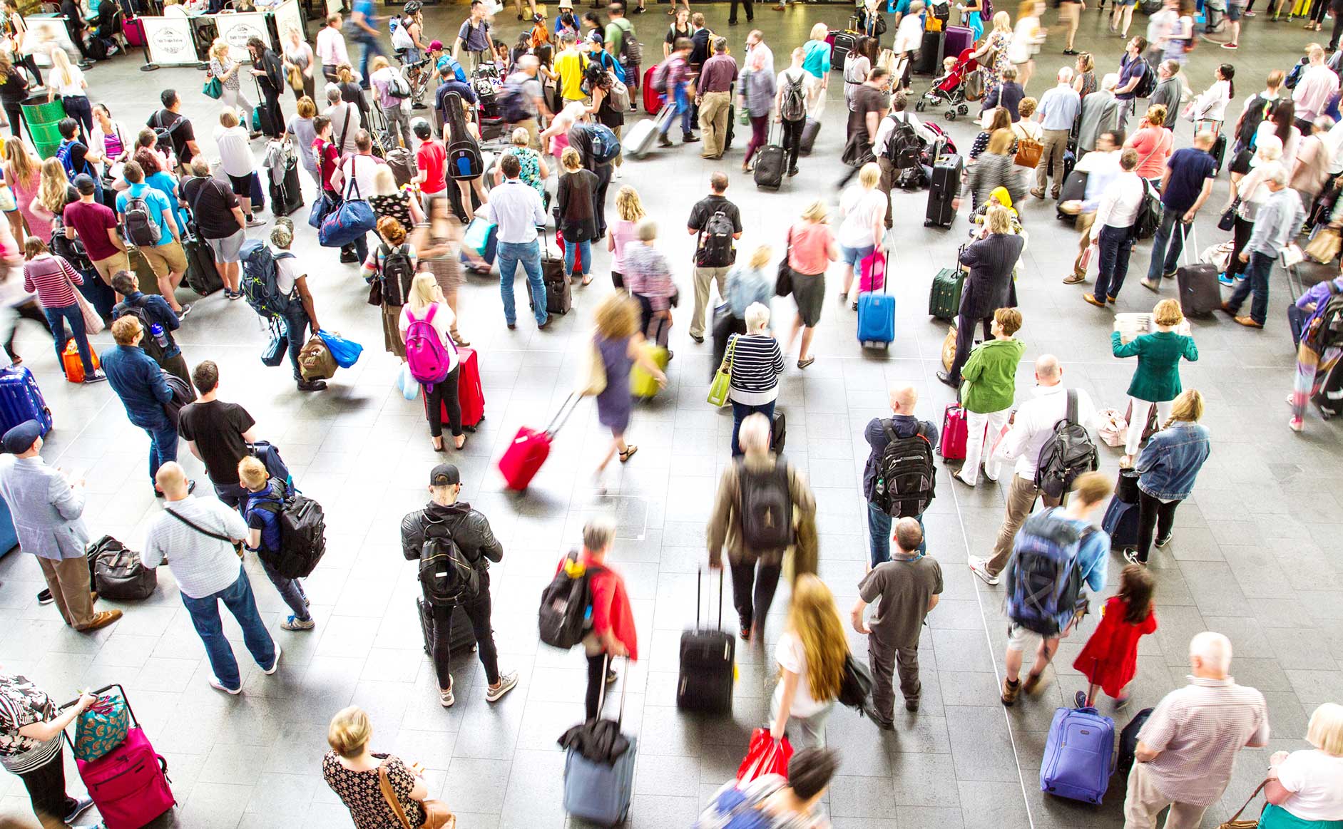 travelers in busy airport concourse