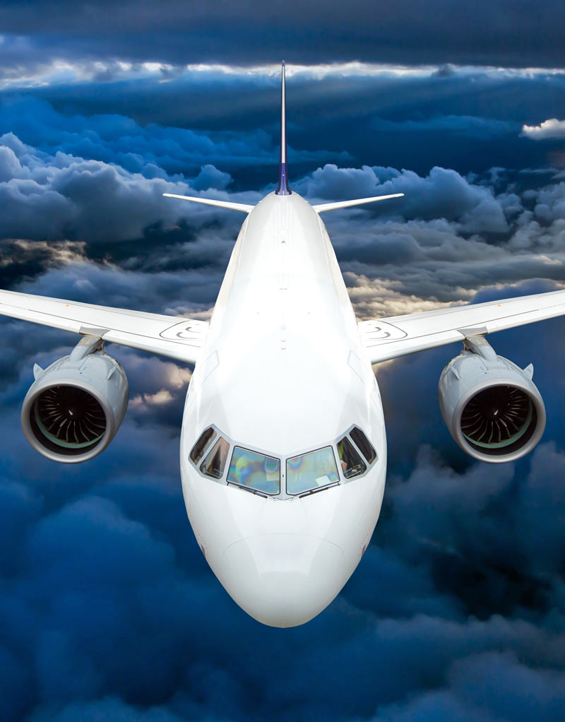 airline jet flying in dark clouds