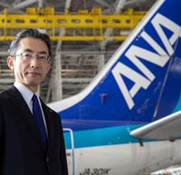 ANA's CEO stands in formt of an aircraft in a hangar. He was interviewed by CIrium about aviation analytics and performance.