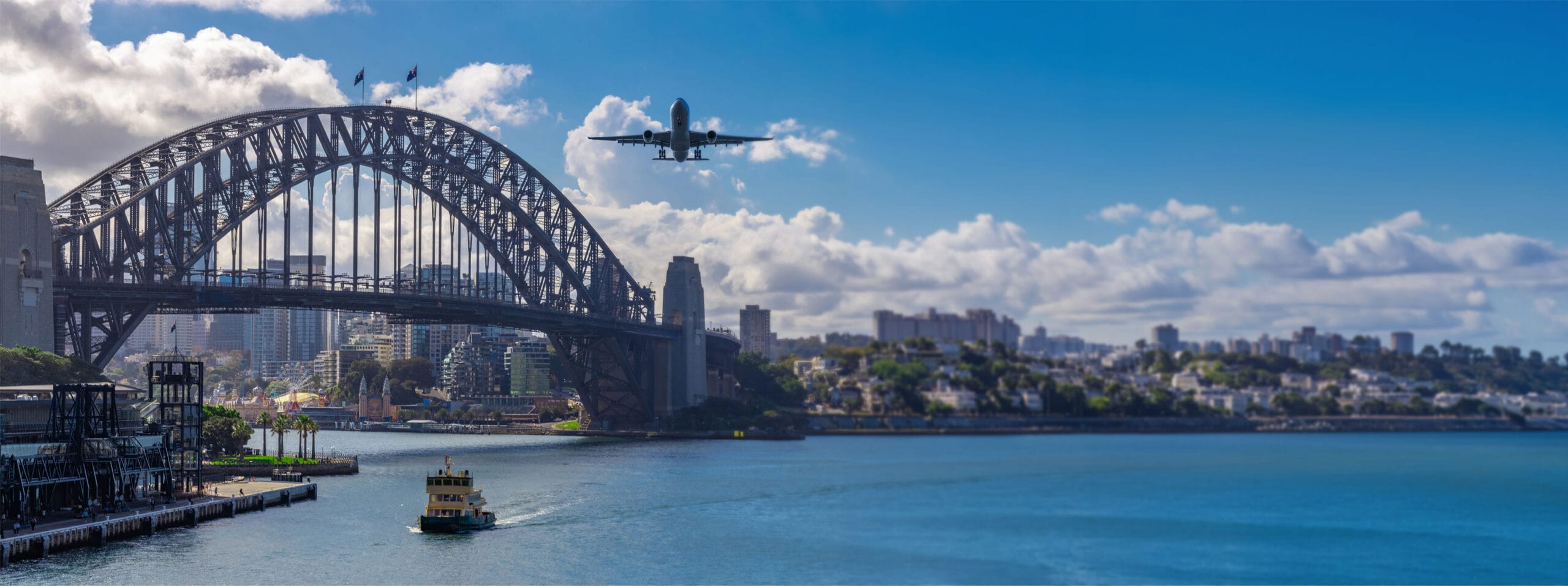 Plane flying over Sydney Harbour Sydney NSW Australia.