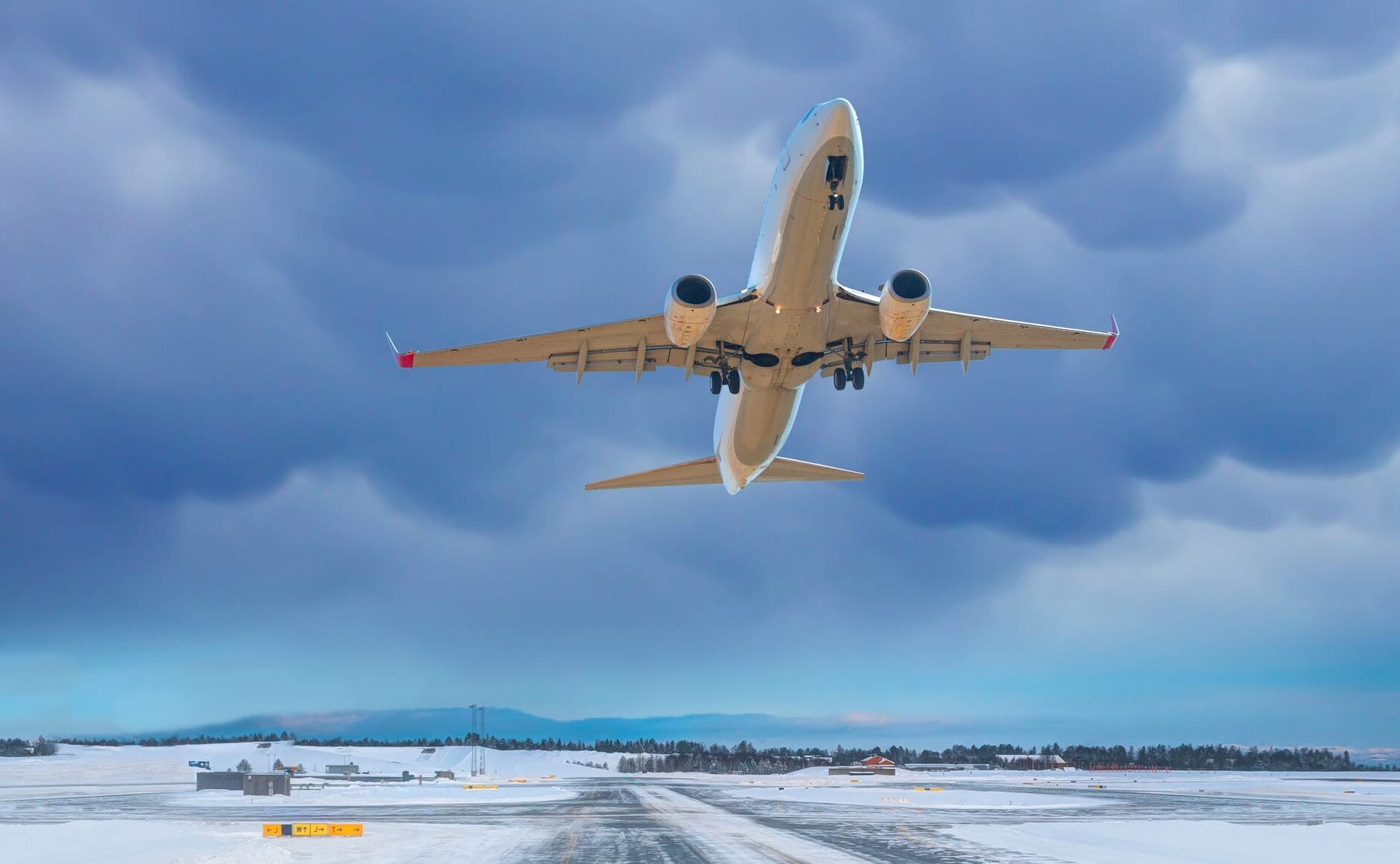 plane taking off from snowy runway
